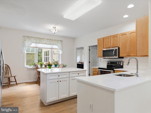 2 Assawoman Ave, Ocean View, DE 19970 - kitchen with appliances with stainless steel finishes, light countertops, light wood-style floors, recessed lighting, and a center island