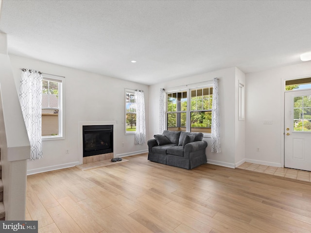 2 Assawoman Ave, Ocean View, DE 19970 - living room with light wood-type flooring, a glass covered fireplace, healthy amount of natural light, and recessed lighting