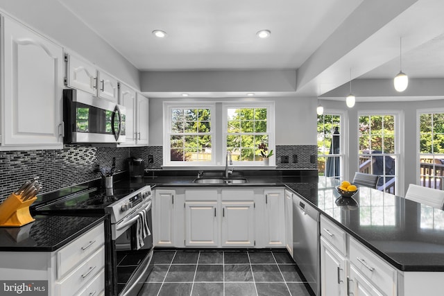 12407 Rousseau Ter, North Potomac, MD 20878 - kitchen with stainless steel appliances, a peninsula, healthy amount of natural light, decorative backsplash, and recessed lighting