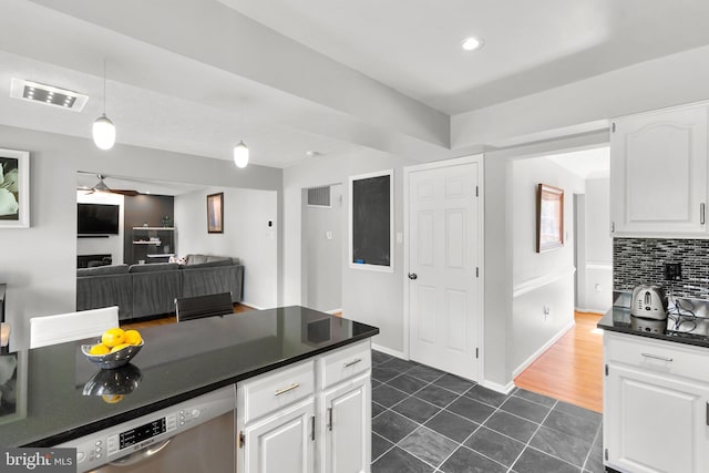 12407 Rousseau Ter, North Potomac, MD 20878 - kitchen with dark countertops, stainless steel dishwasher, dark tile patterned flooring, white cabinetry, and backsplash