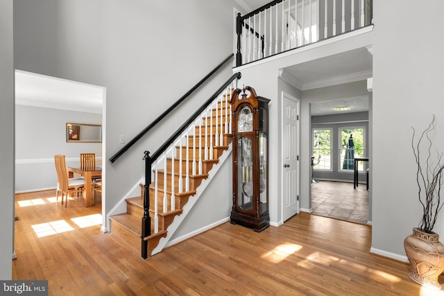 12407 Rousseau Ter, North Potomac, MD 20878 - entryway featuring crown molding, stairway, a high ceiling, and wood finished floors
