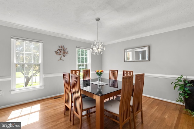 12407 Rousseau Ter, North Potomac, MD 20878 - dining room featuring a chandelier, light wood-style floors, crown molding, and a textured ceiling