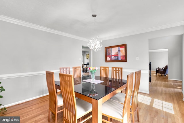 12407 Rousseau Ter, North Potomac, MD 20878 - dining area featuring light wood finished floors, a chandelier, and crown molding