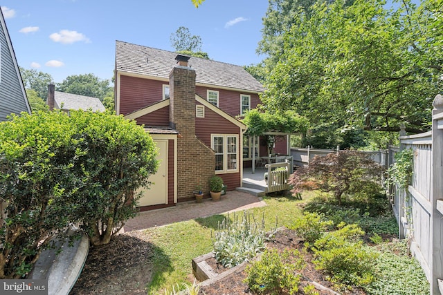 2085 Cobblestone Ln, Reston, VA 20191 - rear view of house with a deck and a chimney