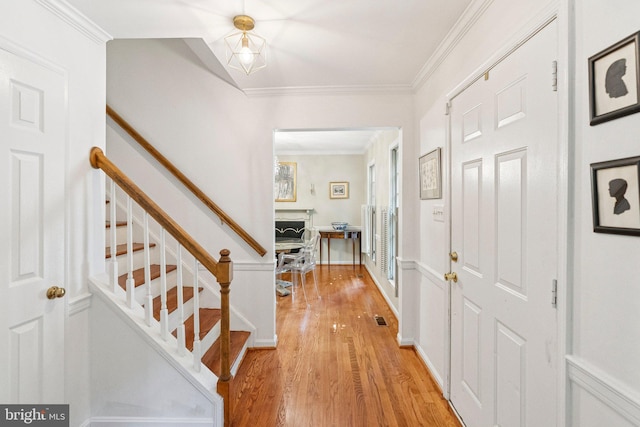 2085 Cobblestone Ln, Reston, VA 20191 - foyer entrance featuring light wood-style floors, stairs, and crown molding
