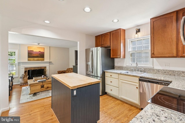 2085 Cobblestone Ln, Reston, VA 20191 - kitchen featuring stainless steel refrigerator with ice dispenser, butcher block countertops, light wood-style flooring, open floor plan, and dishwasher