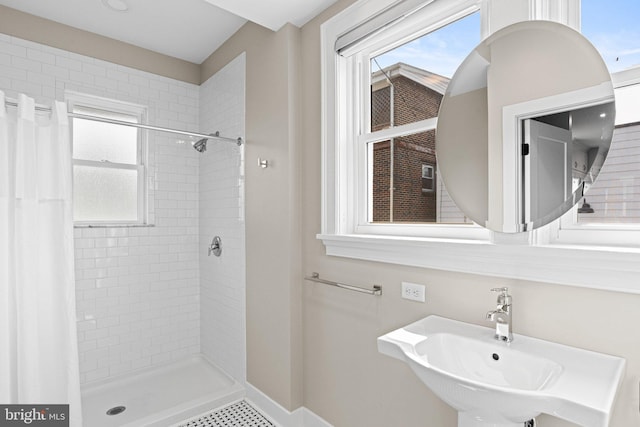 506 W High St, Carlisle, PA 17013 - bathroom featuring a shower stall, a sink, and baseboards