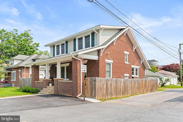 506 W High St, Carlisle, PA 17013 - view of front facade with brick siding and a porch