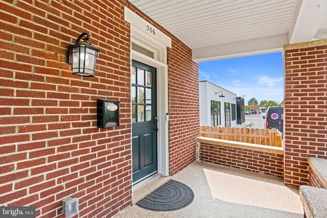 506 W High St, Carlisle, PA 17013 - property entrance featuring covered porch and brick siding