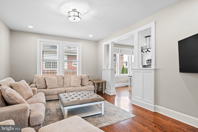 506 W High St, Carlisle, PA 17013 - living area featuring decorative columns, wood finished floors, and baseboards