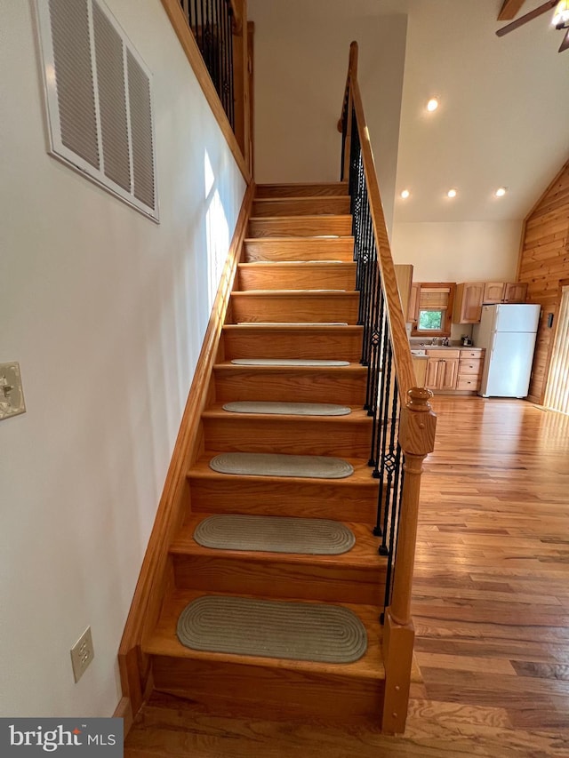 1000 Cardinal View Rd, Paw Paw, WV 25434 - staircase with recessed lighting, wood finished floors, high vaulted ceiling, and ceiling fan