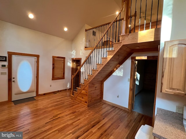 1000 Cardinal View Rd, Paw Paw, WV 25434 - entrance foyer featuring wood finished floors, stairway, high vaulted ceiling, and recessed lighting