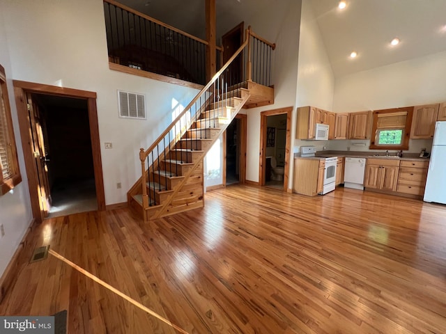 1000 Cardinal View Rd, Paw Paw, WV 25434 - kitchen with white appliances, high vaulted ceiling, light wood-type flooring, and light brown cabinetry