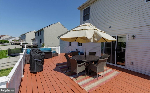 17 Shelly Dr, Reading, PA 19608 - wooden deck with outdoor dining area, a trampoline, and a residential view
