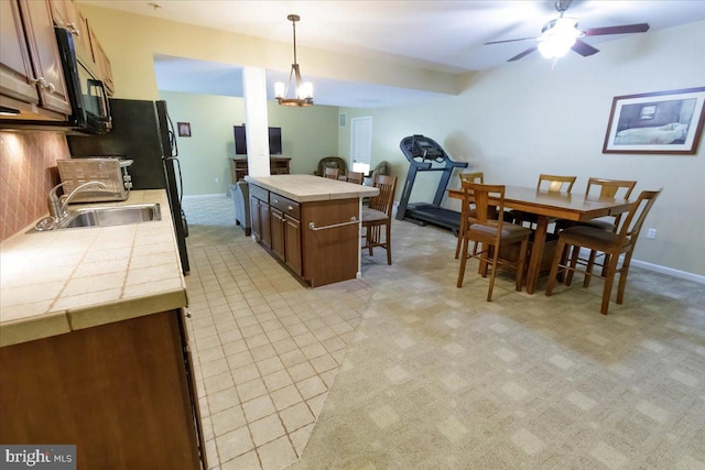 17 Shelly Dr, Reading, PA 19608 - kitchen with tile counters, a sink, black microwave, a ceiling fan, and hanging light fixtures