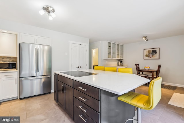 4410 S Pershing Ct, Arlington, VA 22204 - kitchen with stainless steel appliances, light countertops, a kitchen bar, and white cabinets