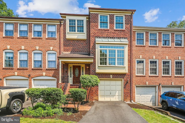 4410 S Pershing Ct, Arlington, VA 22204 - view of property featuring an attached garage, brick siding, and driveway