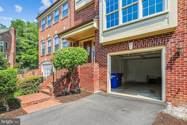 4410 S Pershing Ct, Arlington, VA 22204 - property entrance with a garage, brick siding, and driveway