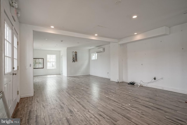 318 12th St, Hammonton, NJ 08037 - spare room featuring an AC wall unit, recessed lighting, wood finished floors, healthy amount of natural light, and baseboards