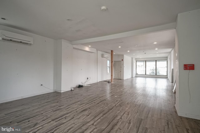 318 12th St, Hammonton, NJ 08037 - unfurnished living room with a wall mounted air conditioner, wood finished floors, recessed lighting, and baseboards