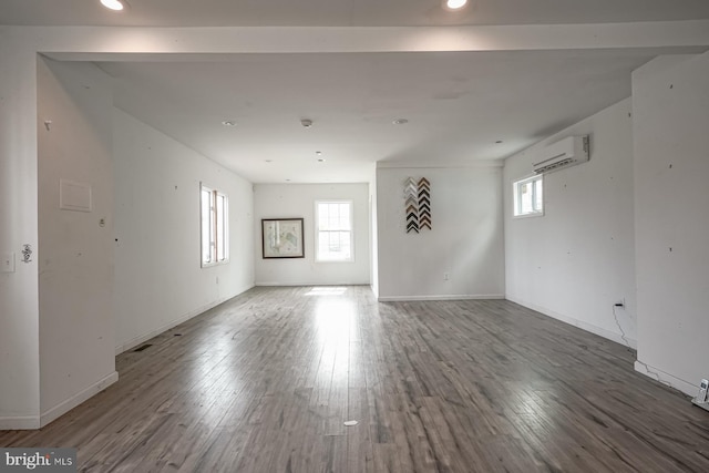 318 12th St, Hammonton, NJ 08037 - spare room with an AC wall unit, wood finished floors, recessed lighting, and baseboards