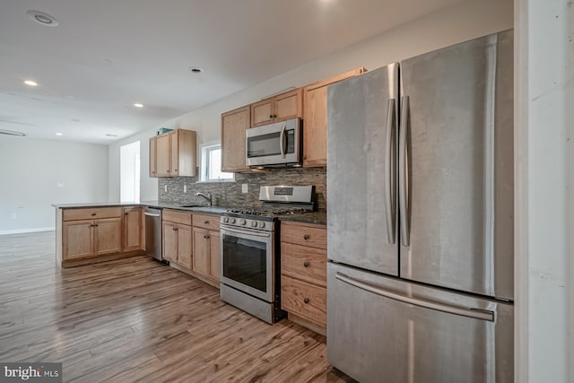 318 12th St, Hammonton, NJ 08037 - kitchen with stainless steel appliances, light brown cabinets, a peninsula, backsplash, and recessed lighting
