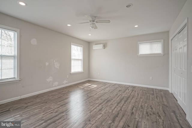 318 12th St, Hammonton, NJ 08037 - unfurnished bedroom with an AC wall unit, wood finished floors, a closet, baseboards, and recessed lighting