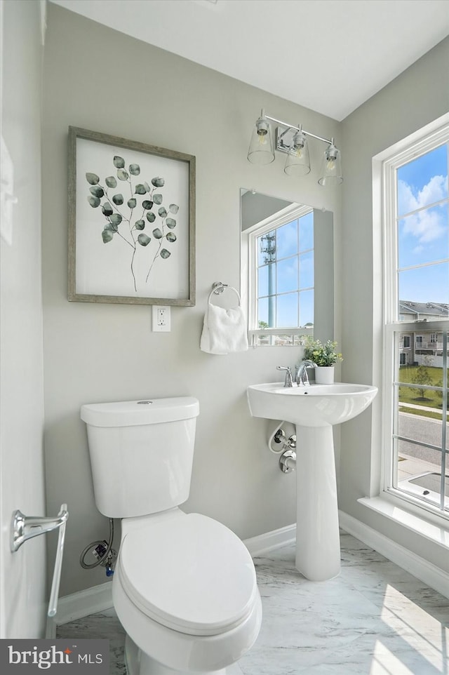 7710 Village Park Dr, Baltimore, MD 21222 - bathroom featuring marble look tiles, baseboards, and toilet