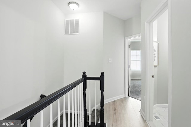 7710 Village Park Dr, Baltimore, MD 21222 - hallway with an upstairs landing, baseboards, and light wood-style flooring