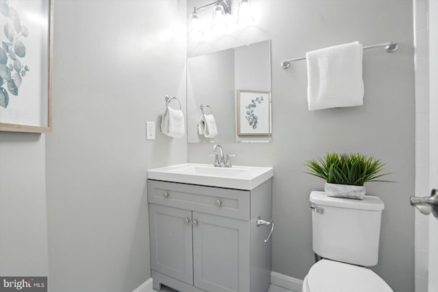 7710 Village Park Dr, Baltimore, MD 21222 - bathroom with toilet, vanity, and baseboards
