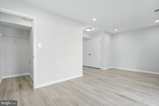 7710 Village Park Dr, Baltimore, MD 21222 - unfurnished bedroom featuring wood finished floors, a spacious closet, baseboards, recessed lighting, and a closet