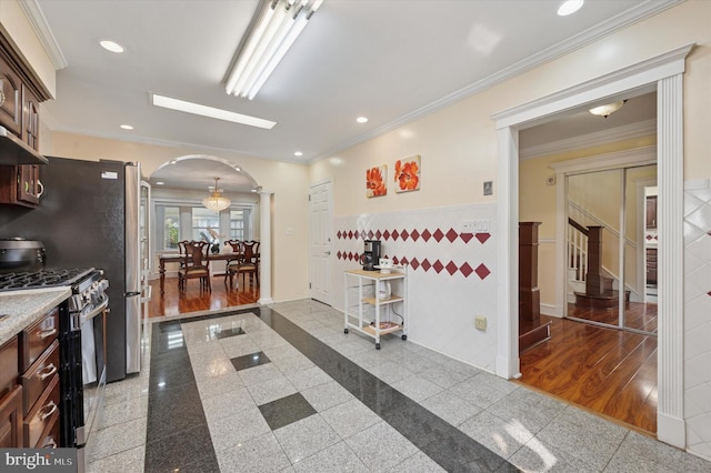 7200 Wayne Ave, Upper Darby, PA 19082 - kitchen with stainless steel range with gas cooktop, arched walkways, granite tiled floors, under cabinet range hood, and recessed lighting