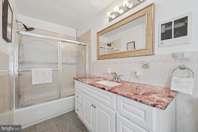 7200 Wayne Ave, Upper Darby, PA 19082 - full bathroom featuring vanity, bath / shower combo with glass door, and tile walls