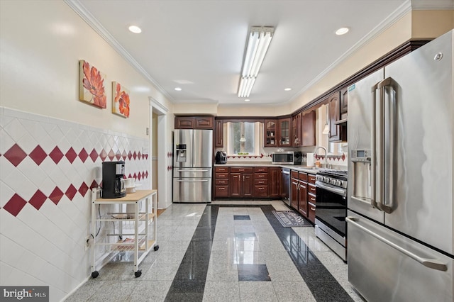 7200 Wayne Ave, Upper Darby, PA 19082 - kitchen featuring appliances with stainless steel finishes, tile walls, light countertops, ornamental molding, and a wainscoted wall