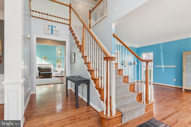 14520 Fairdale Rd, Silver Spring, MD 20905 - staircase with wood-type flooring, healthy amount of natural light, crown molding, baseboards, and a high ceiling