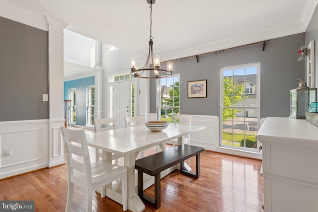14520 Fairdale Rd, Silver Spring, MD 20905 - dining space with crown molding, a chandelier, light wood-type flooring, a decorative wall, and a wainscoted wall