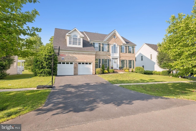 14520 Fairdale Rd, Silver Spring, MD 20905 - colonial-style house featuring driveway, a garage, a front lawn, and brick siding