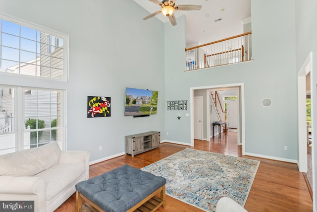 14520 Fairdale Rd, Silver Spring, MD 20905 - living area with a towering ceiling, stairway, plenty of natural light, and baseboards