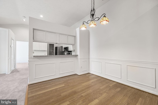 12200 Eagles Nest Ct Unit L, Germantown, MD 20874 - unfurnished dining area with vaulted ceiling, recessed lighting, light wood-style flooring, a chandelier, and wainscoting