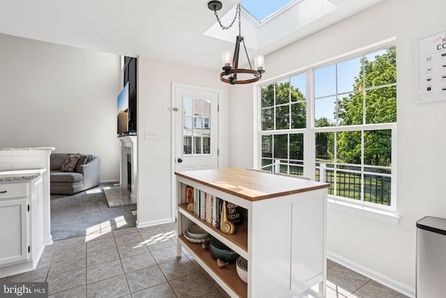 1112 Cornwallis Way, Collegeville, PA 19426 - dining area featuring a chandelier, a skylight, healthy amount of natural light, and a fireplace