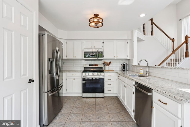 1112 Cornwallis Way, Collegeville, PA 19426 - kitchen featuring stainless steel appliances, a sink, backsplash, white cabinetry, and recessed lighting