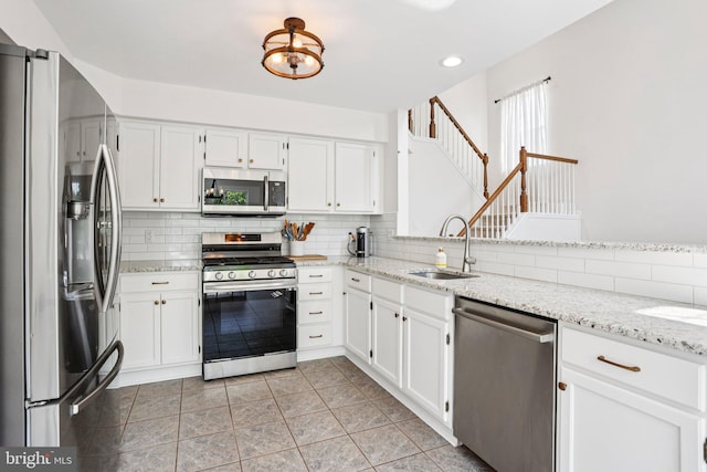 1112 Cornwallis Way, Collegeville, PA 19426 - kitchen featuring stainless steel appliances, a sink, white cabinetry, light stone countertops, and recessed lighting