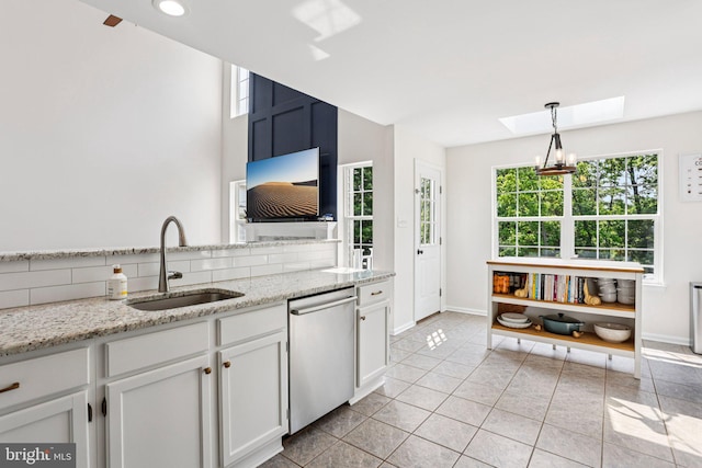 1112 Cornwallis Way, Collegeville, PA 19426 - kitchen with dishwasher, a sink, a skylight, white cabinetry, and baseboards
