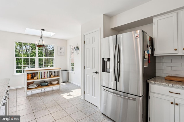 1112 Cornwallis Way, Collegeville, PA 19426 - kitchen featuring stainless steel fridge, a skylight, light tile patterned flooring, tasteful backsplash, and light stone countertops