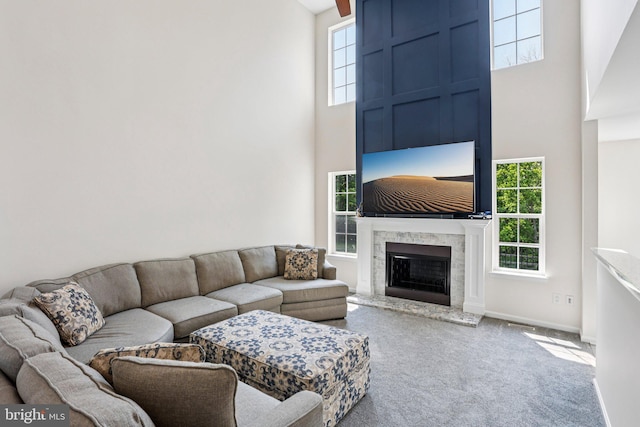 1112 Cornwallis Way, Collegeville, PA 19426 - living room featuring a high ceiling, carpet floors, a fireplace with raised hearth, and baseboards