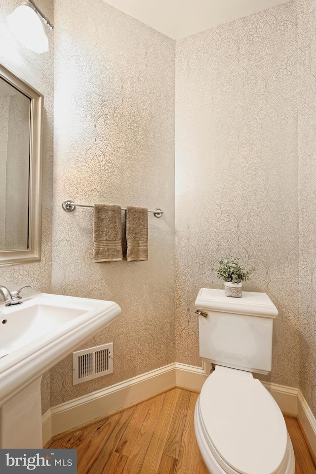 404 Oronoco St, Alexandria, VA 22314 - bathroom featuring wood finished floors and wallpapered walls