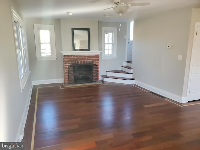 3004 Dekalb Pike, East Norriton, PA 19401 - unfurnished living room with wood finished floors, a ceiling fan, stairway, and a brick fireplace