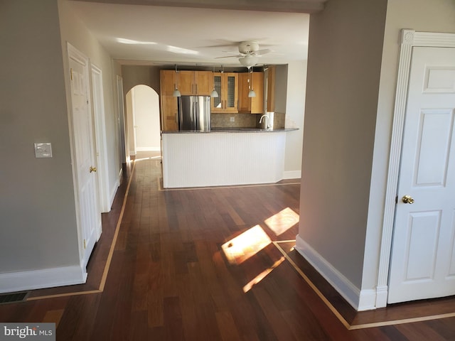 3004 Dekalb Pike, East Norriton, PA 19401 - unfurnished living room with arched walkways, a ceiling fan, baseboards, dark wood-type flooring, and a sink