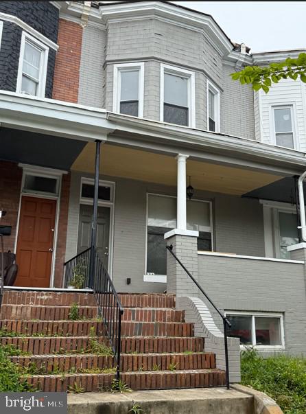 434 E 28th St, Baltimore, MD 21218 - view of front of house featuring stairway, a porch, and brick siding