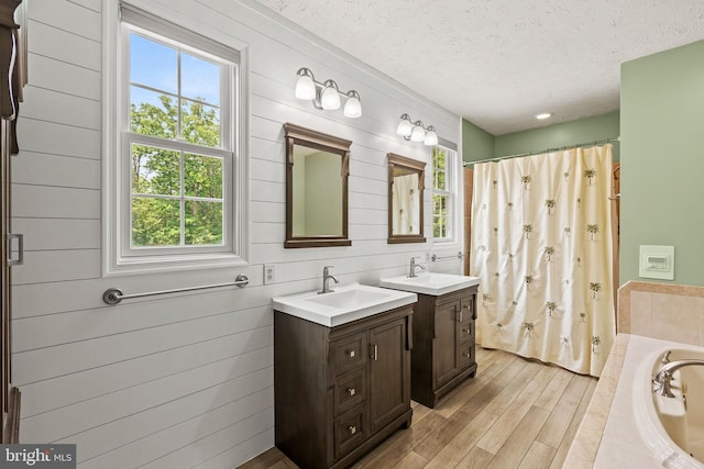26471 N Sandgates Rd, Mechanicsville, MD 20659 - bathroom with a textured ceiling, plenty of natural light, a shower with curtain, and wood finished floors